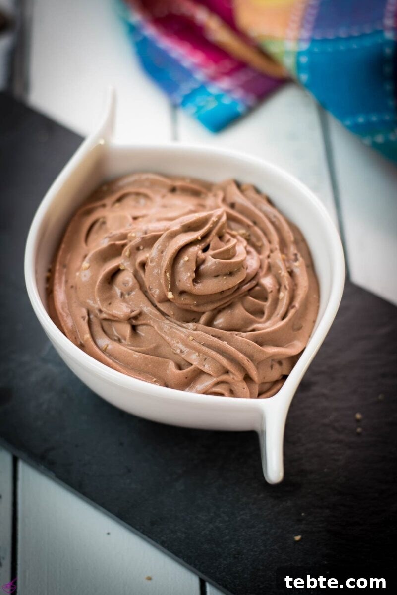 Rich Homemade Dark Chocolate Pudding Recipe — Silky & Decadent 4 White ceramic bowl filled with delicious dark chocolate pudding on black slate plate.