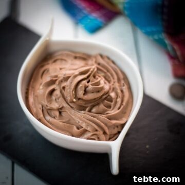 Rich Homemade Dark Chocolate Pudding Recipe — Silky & Decadent 6 White ceramic bowl filled with delicious dark chocolate pudding on black slate plate.
