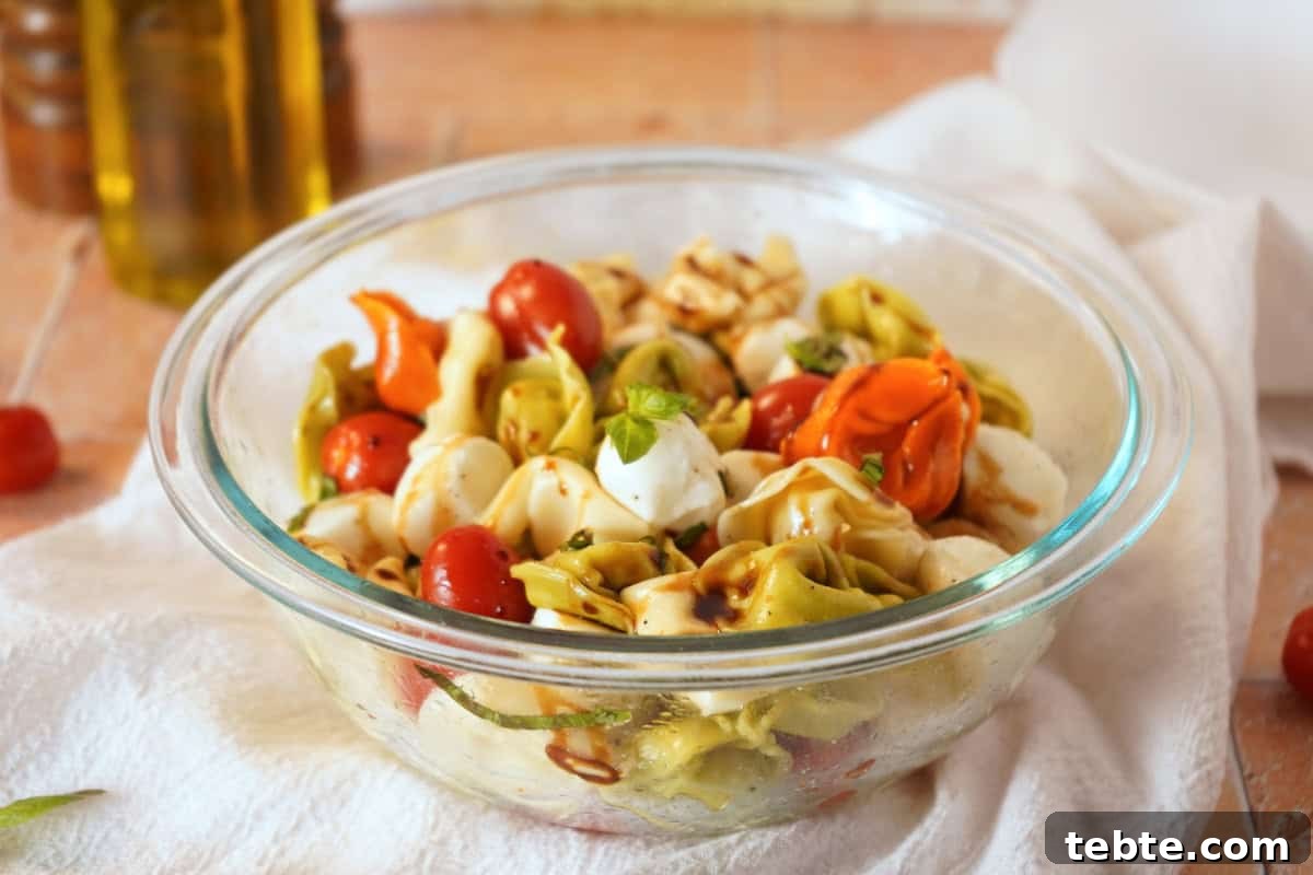Caprese Tortellini Salad with Cherry Tomatoes & Basil 3 caprese pasta salad close up with olive oil in background