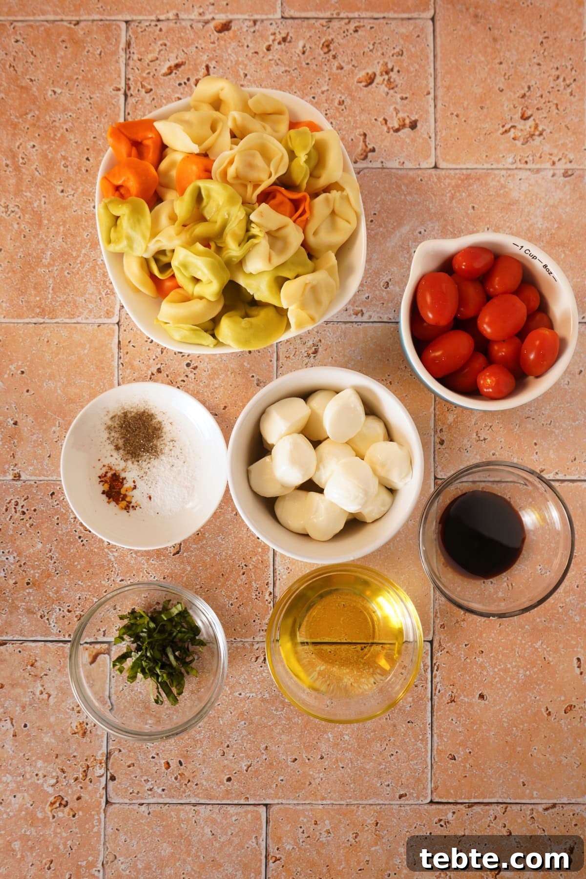 Caprese Tortellini Salad with Cherry Tomatoes & Basil 4 caprese tortellini pasta salad ingredients on table