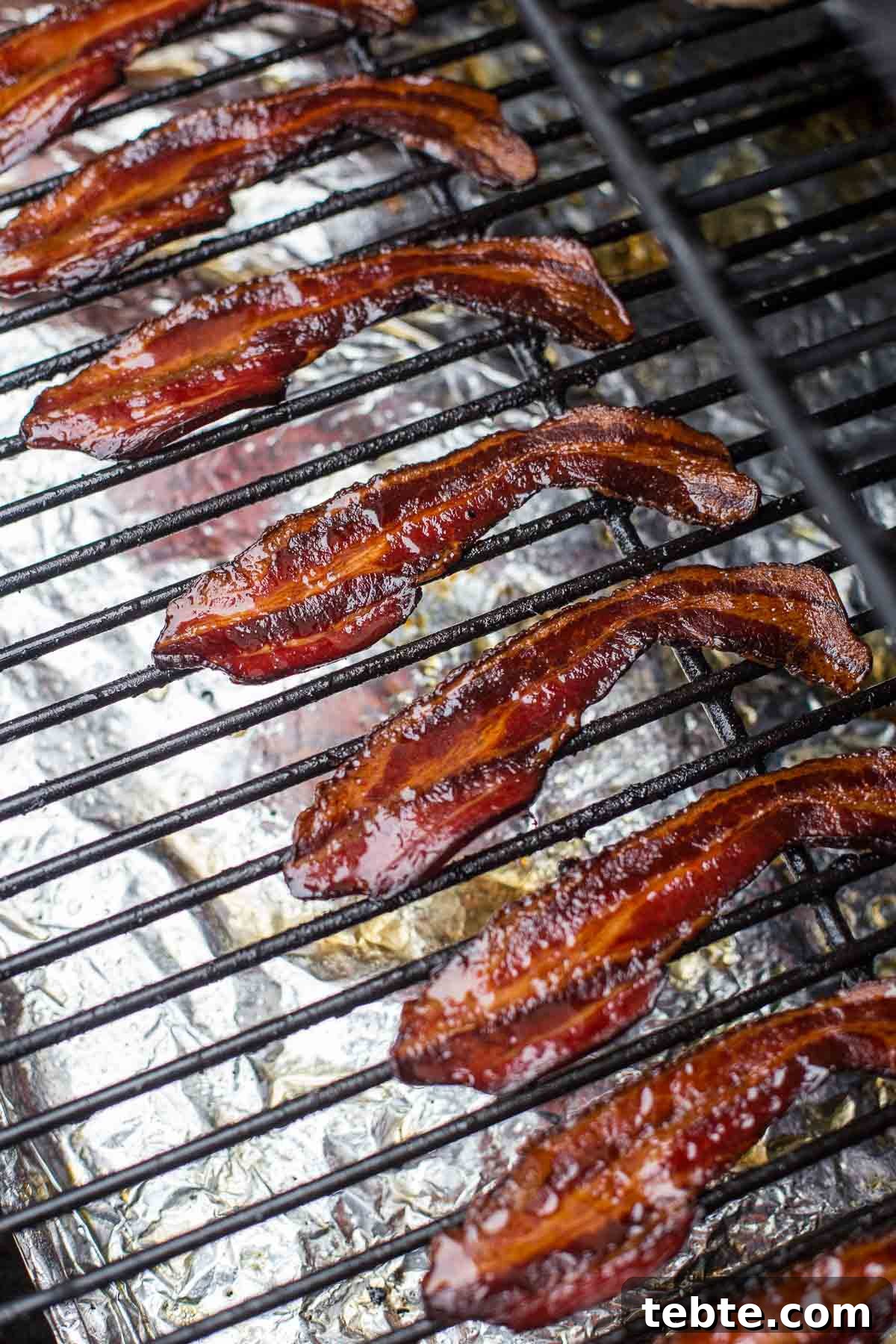 Crispy Smoked Bacon with Maple Glaze Recipe and Tips 3 Smoking slices of Bacon on a smoker