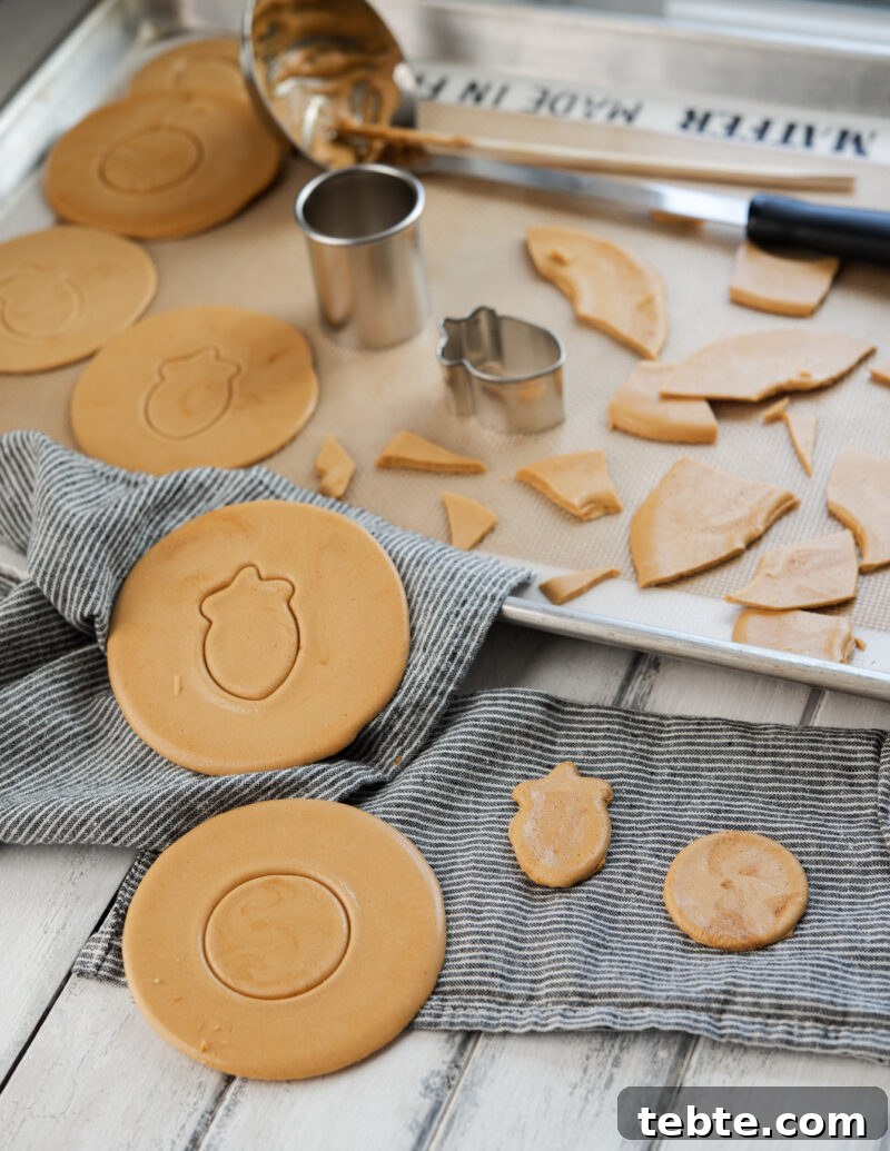 5-Minute Dalgona Candy Recipe: Crispy Korean Sugar Treat 4 Dalgona patterns are picked out and presented over a napkin.