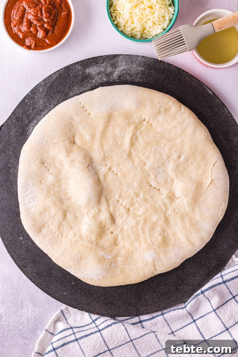par baked pizza crust on a pizza stone