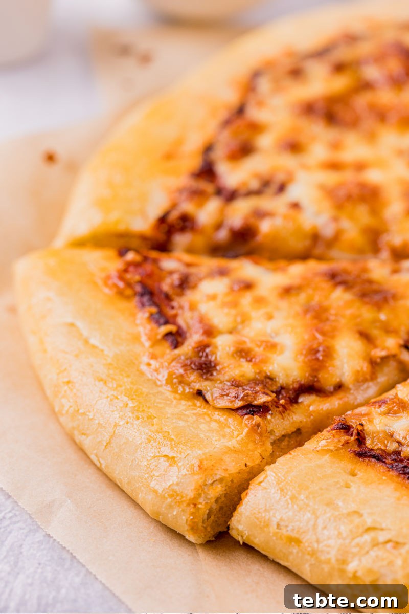 close up of the pizza crust of a sliced cheese pizza