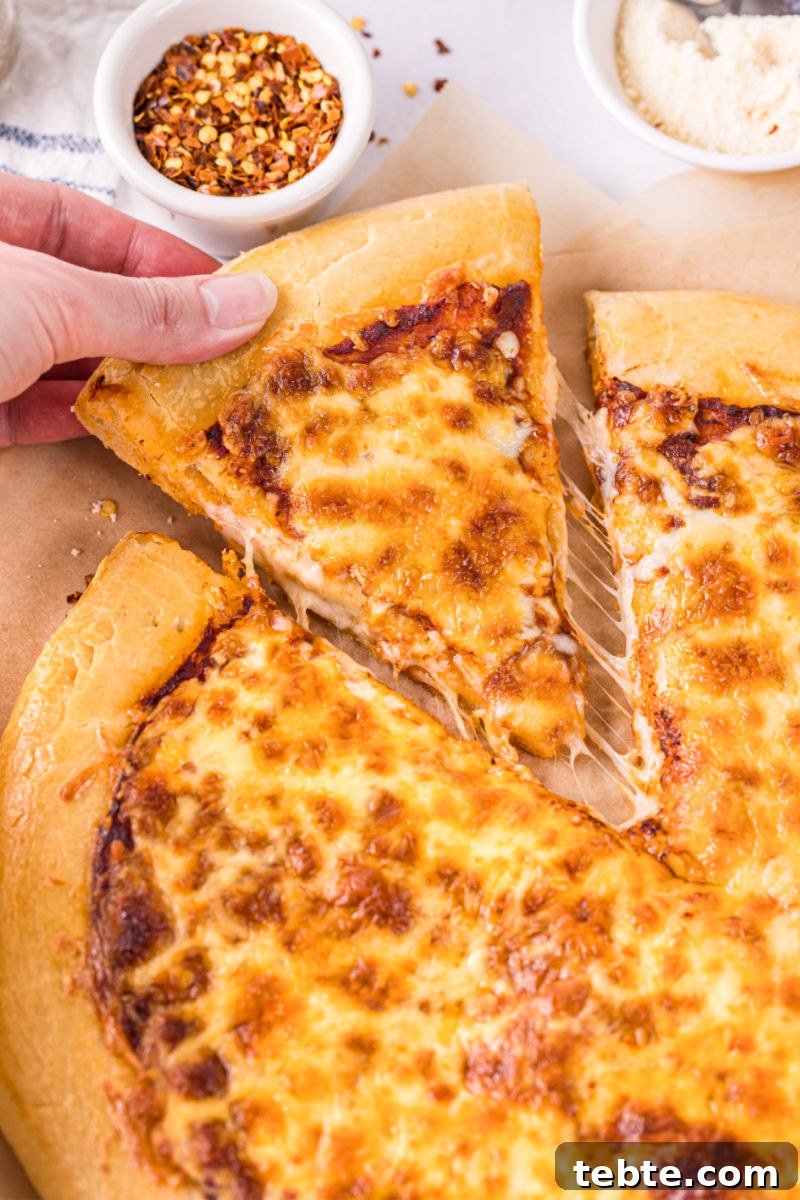 slice of cheese pizza being pulled by a hand