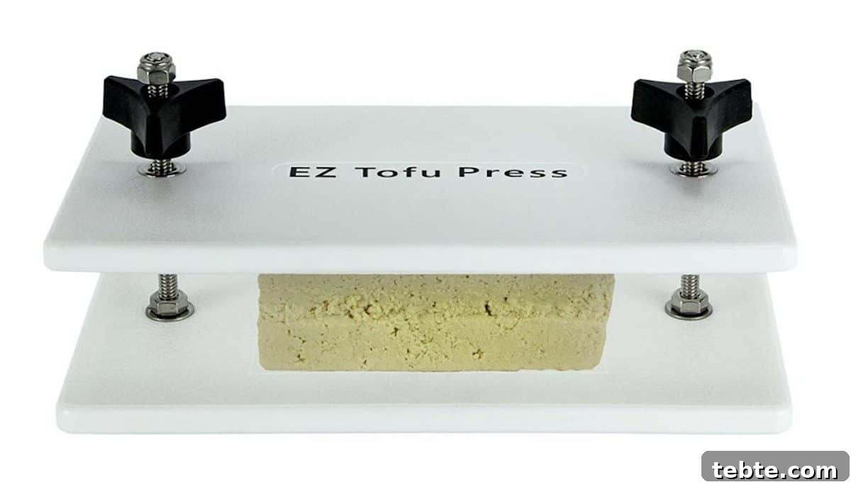 A tofu press with tofu in the center of the press on the counter. 