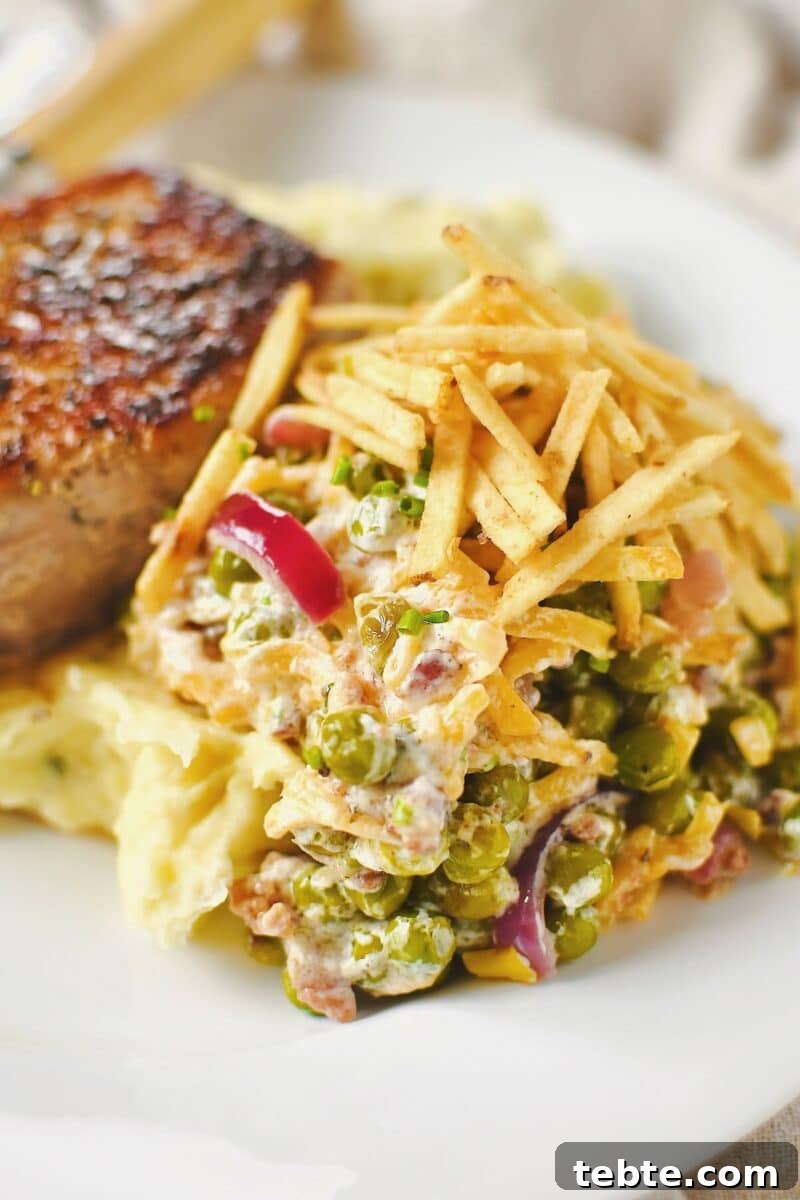 Creamy Pea Salad with Bacon and Red Onion 9 Bacon Pea Salad served on the side of mashed potatoes and pork chops.