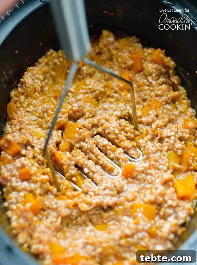 Mashing the butternut squash oatmeal in crockpot