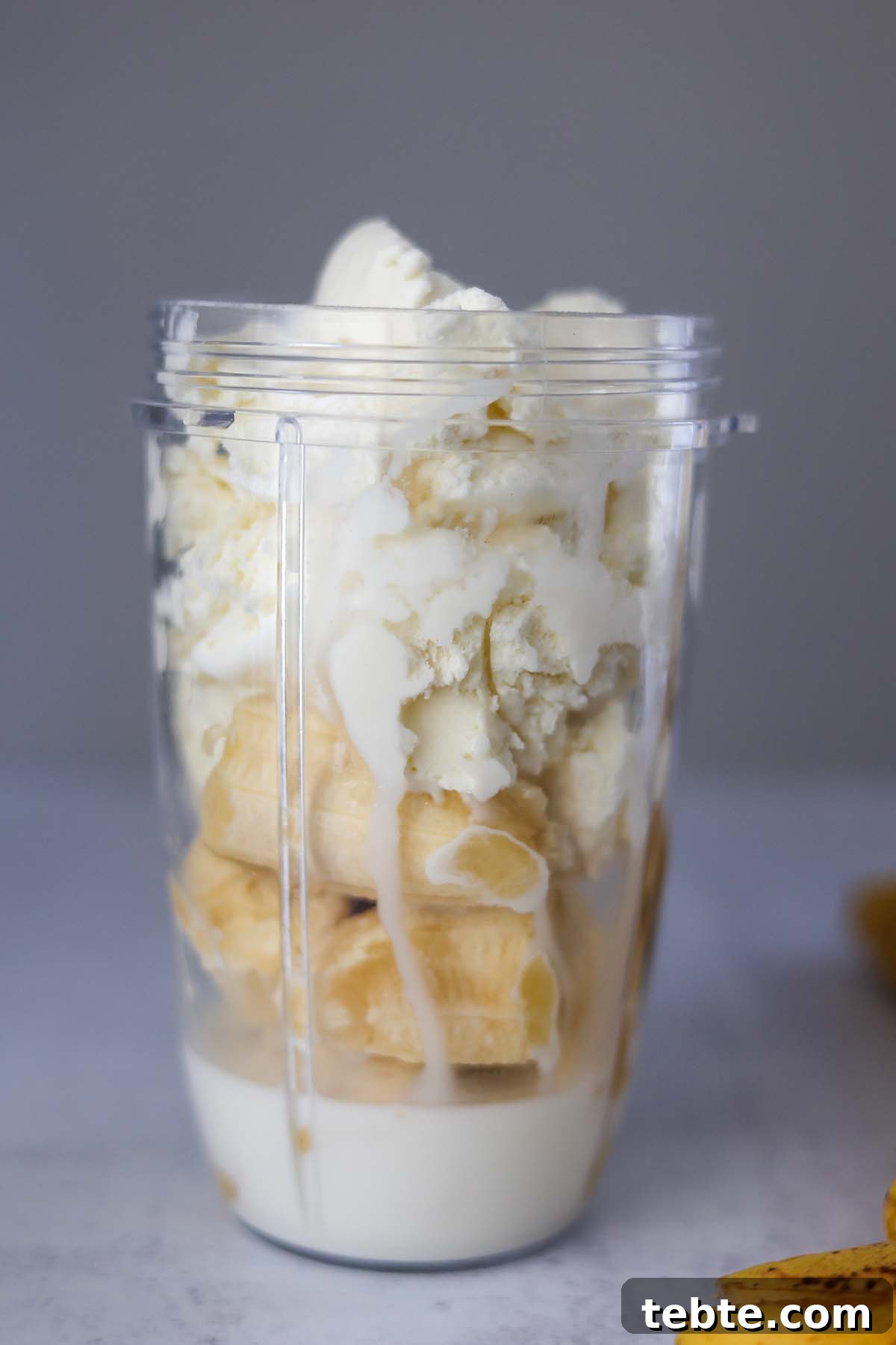 Creamy Banana Milkshake Recipe for Thick, Frosty Results 4 bananas, milk, and ice cream in a blender.
