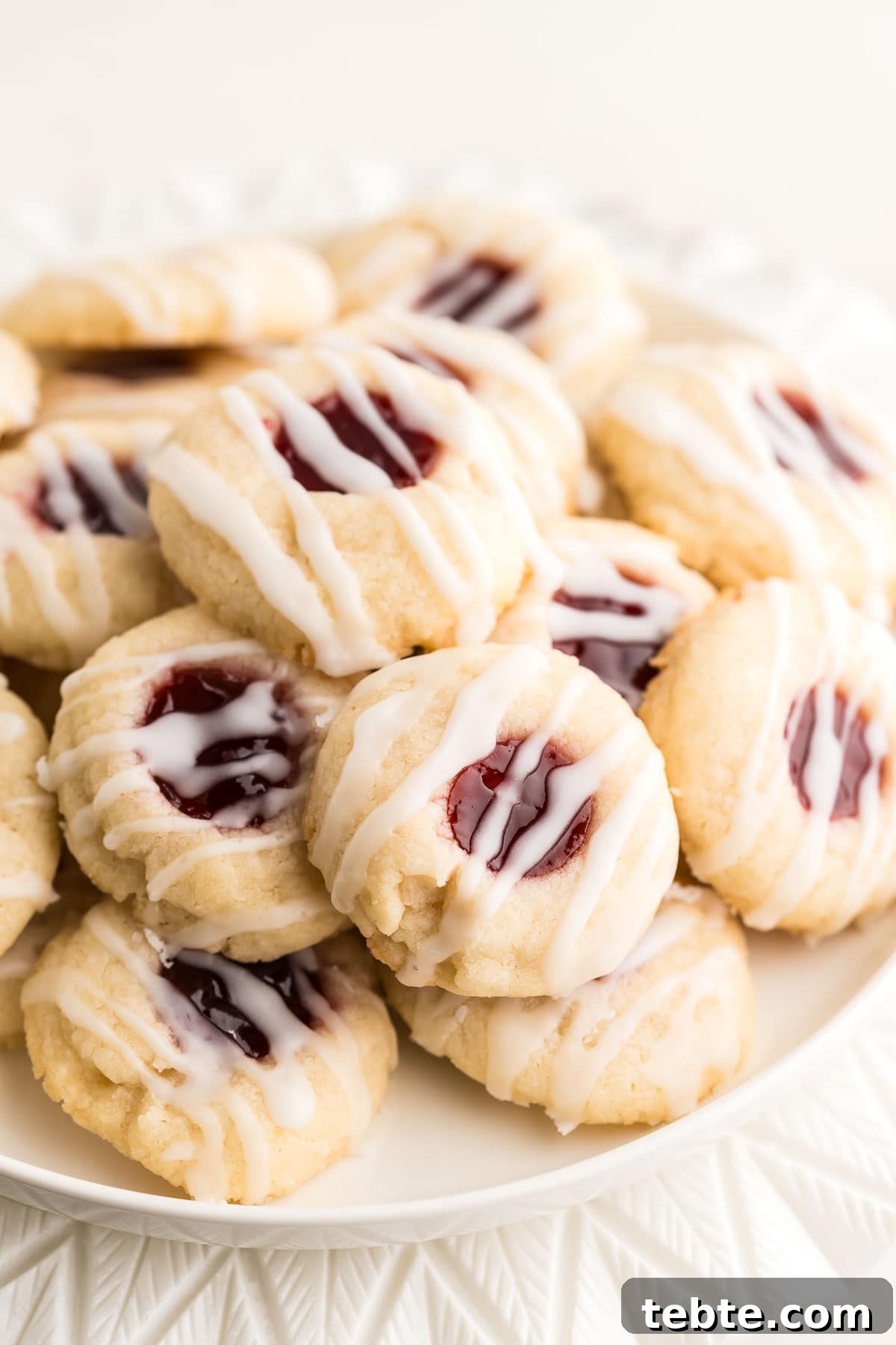 Raspberry Almond Shortbread Cookies Recipe — Buttery Jam-Filled Treats 16 Stacked cookies