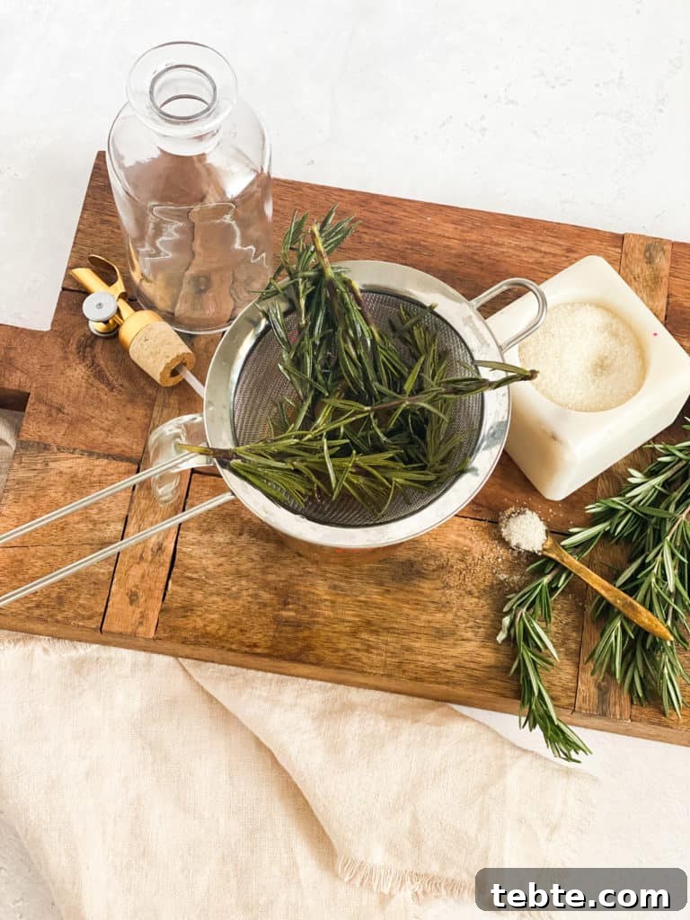 Rosemary Simple Syrup in a strainer