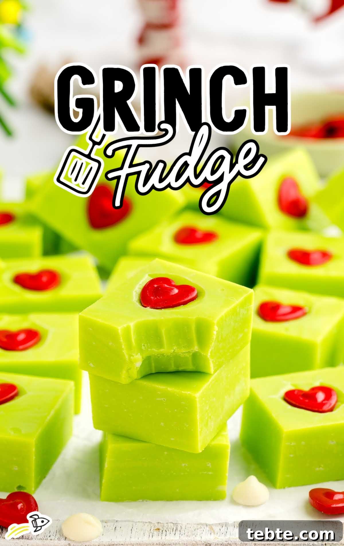 Green Grinch Fudge Recipe: Festive Candy for Holiday Gifting 2 a close up shot of pieces of Grinch Fudge stacked on top of each other with one having a bite taken out of it