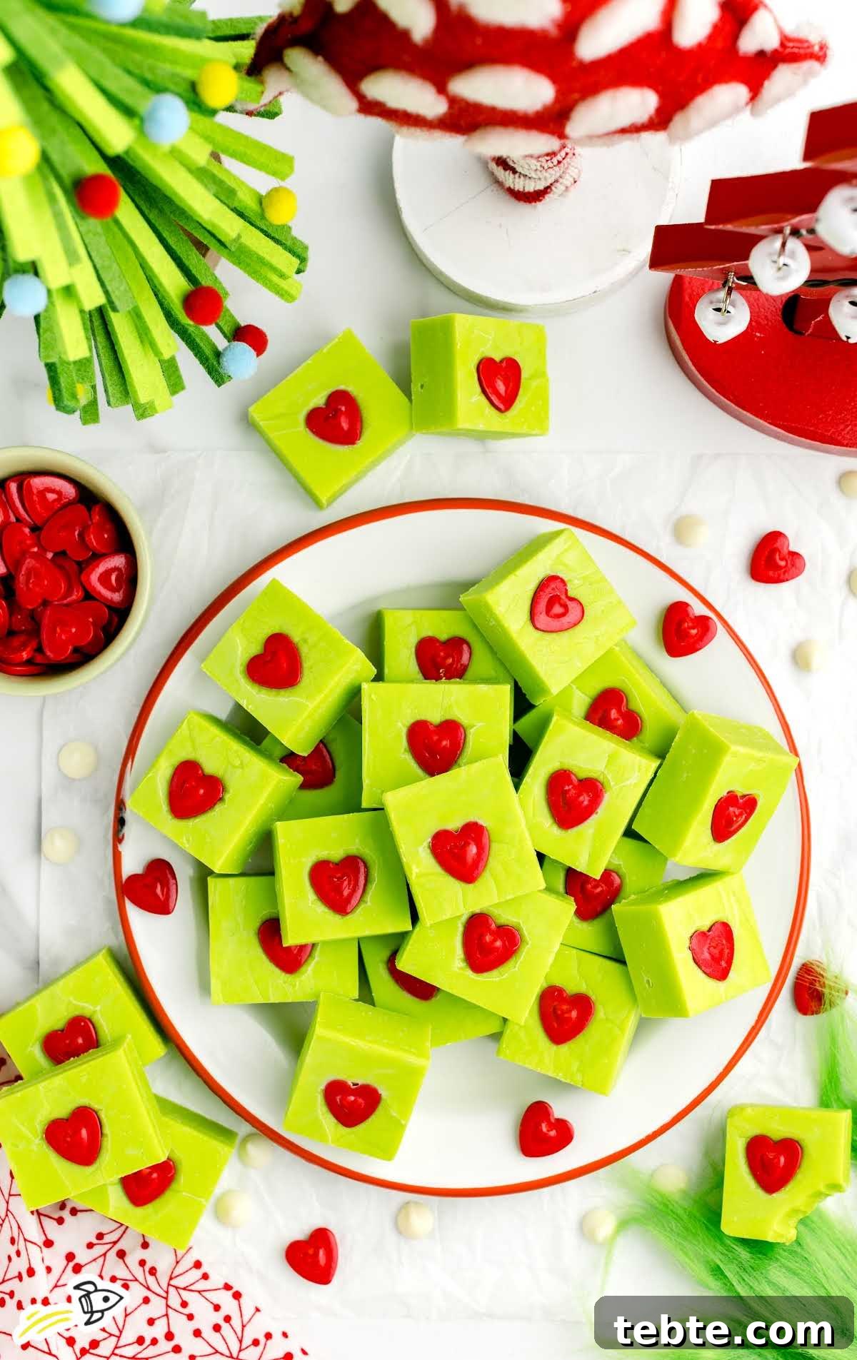 Green Grinch Fudge Recipe: Festive Candy for Holiday Gifting 8 overhead shot of pieces of Grinch Fudge on a plate stacked on top of each other
