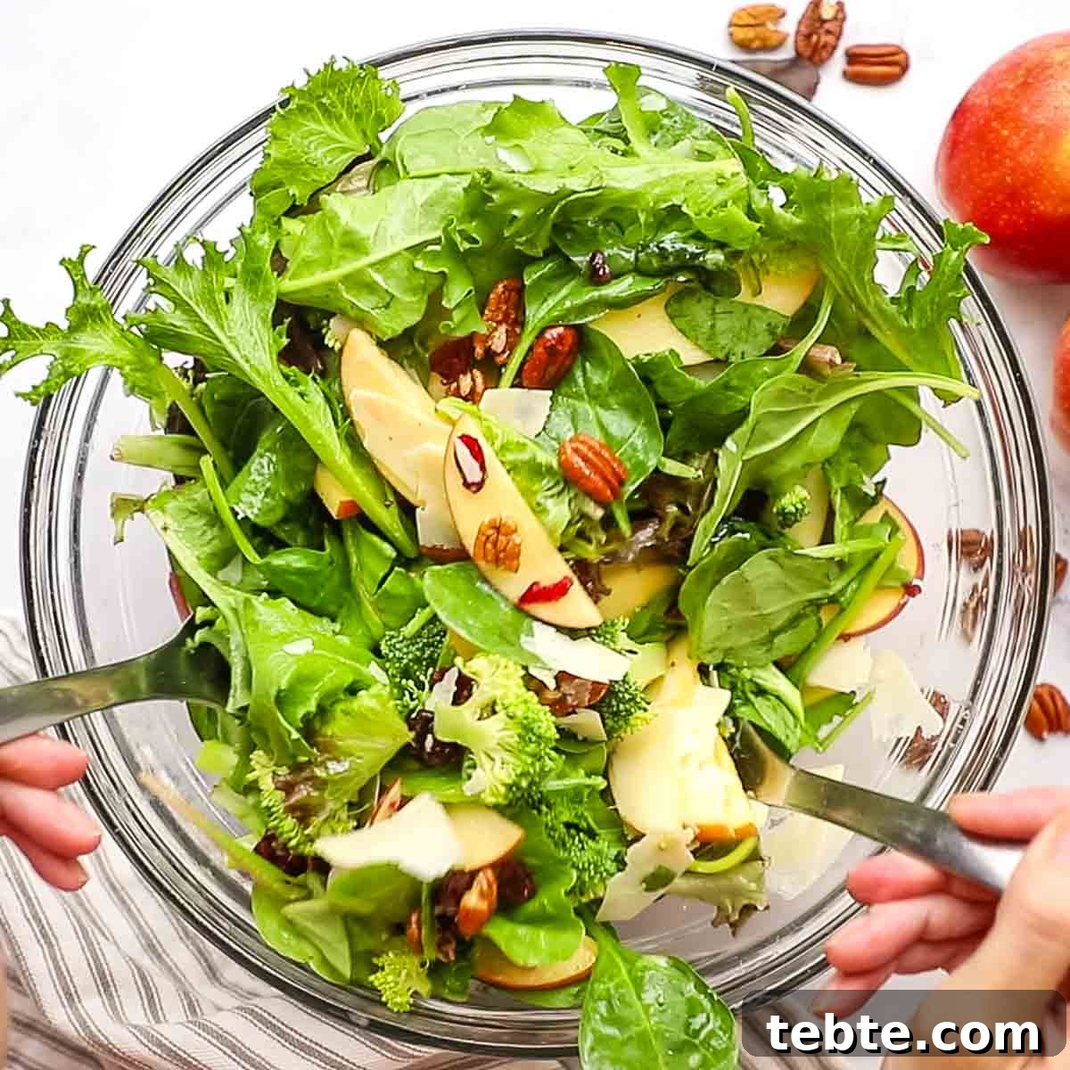 Crisp Apple and Pecan Salad with Maple Vinaigrette 10 mixing the apple pecan salad together