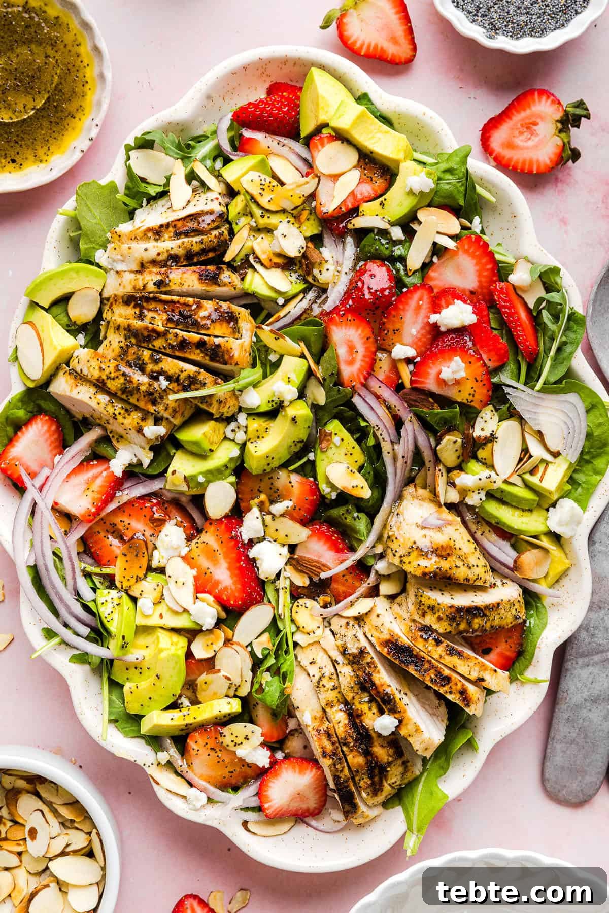 This Strawberry Poppy Seed Chicken Salad is fresh, flavorful, and perfect for spring and summer! Made with juicy strawberries, tender chicken, crunchy toppings, and the BEST poppy seed dressing.