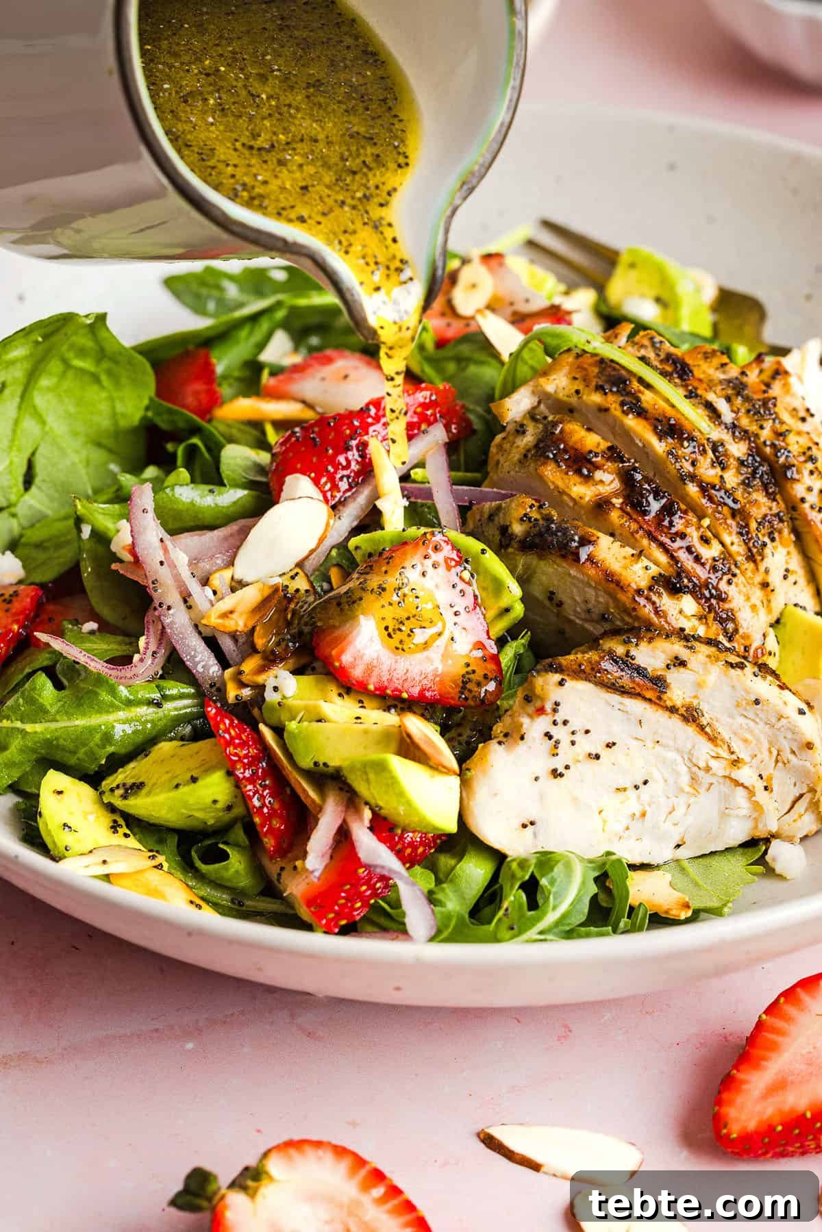 This Strawberry Poppy Seed Chicken Salad is fresh, flavorful, and perfect for spring and summer! Made with juicy strawberries, tender chicken, crunchy toppings, and the BEST poppy seed dressing.