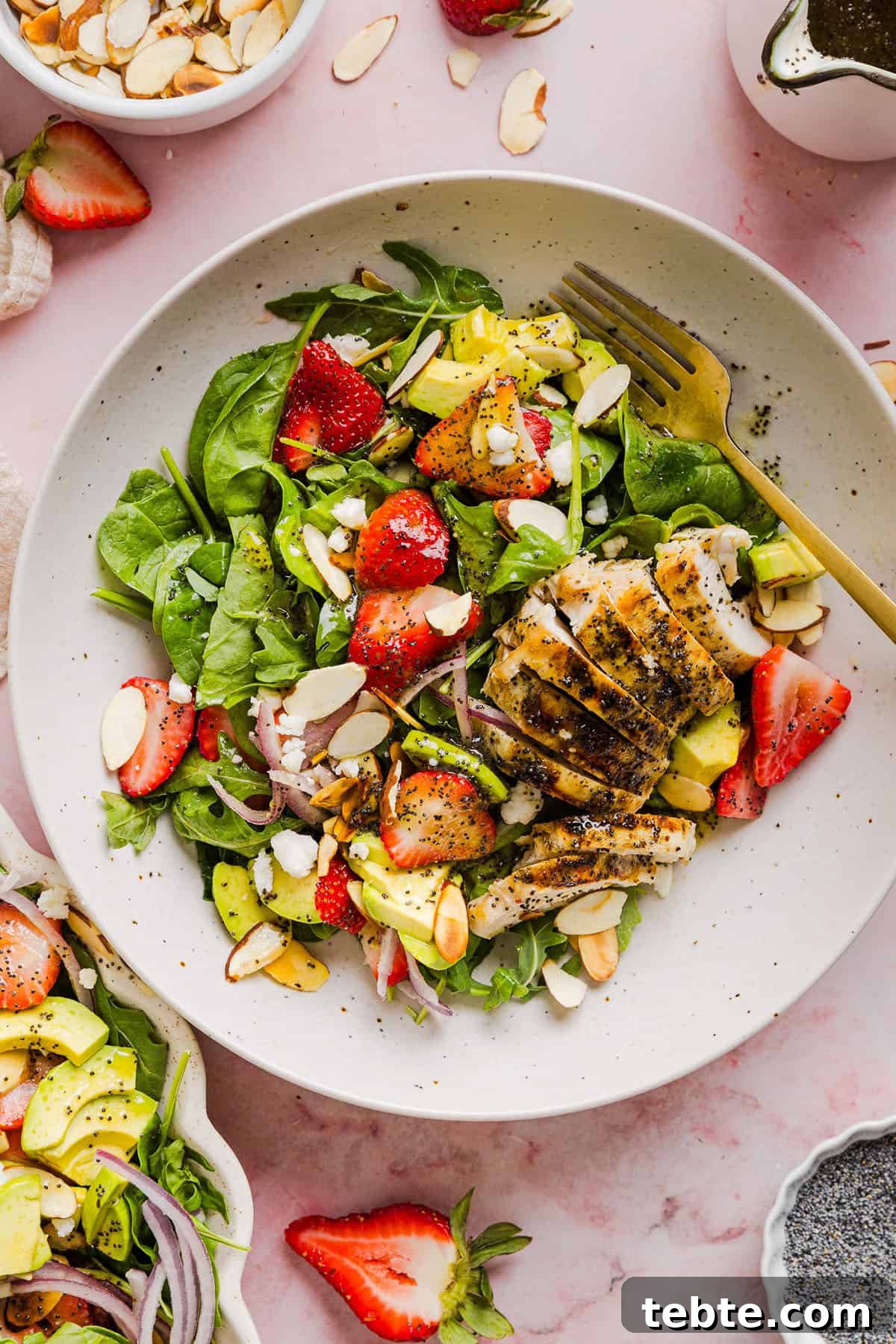 This Strawberry Poppy Seed Chicken Salad is fresh, flavorful, and perfect for spring and summer! Made with juicy strawberries, tender chicken, crunchy toppings, and the BEST poppy seed dressing.