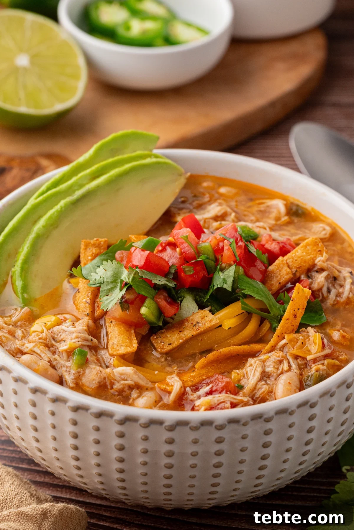 Slow-Cooker White Chicken Chili Recipe (Low-Calorie Crock-Pot) 3 bowl of shredded white chicken chili with tortilla strips, pico de Gallo and avocado
