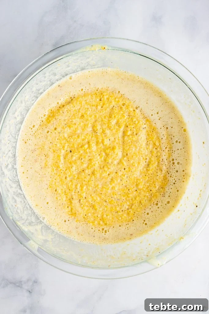 mixed yellow batter in a glass mixing bowl