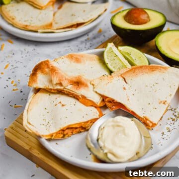 The quesadillas are served with avocado and sour cream