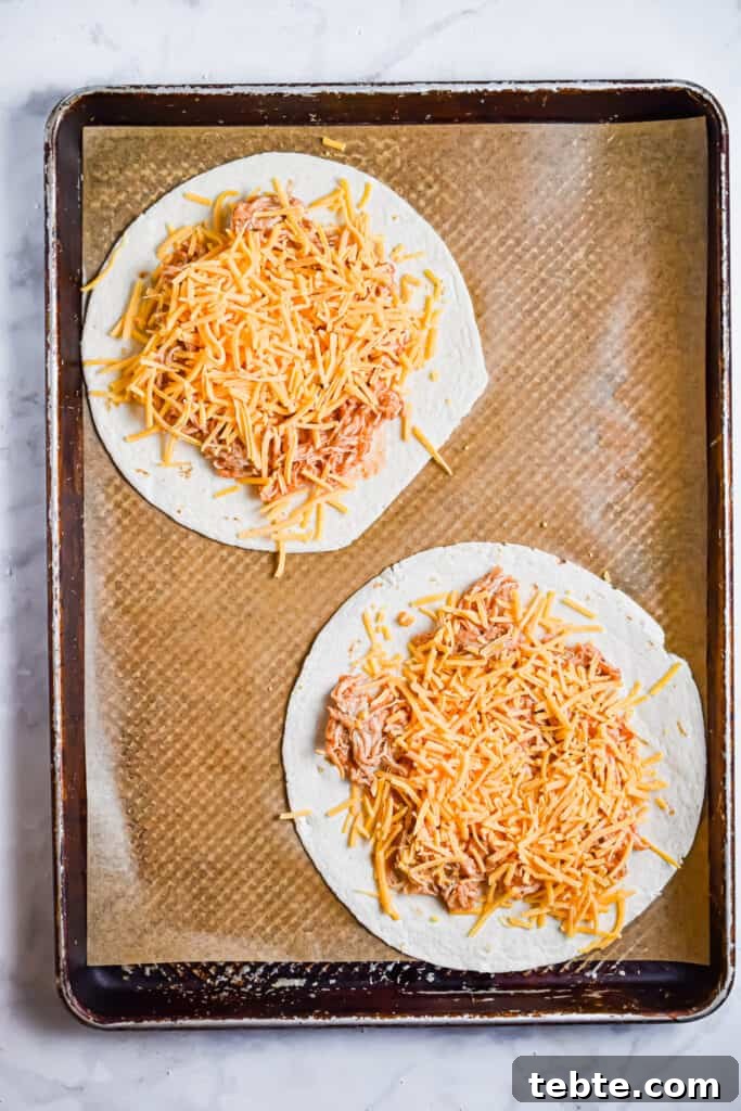 Tortillas are topped with the chicken mixture and cheese.