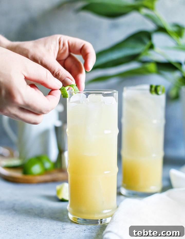 Classic Mai Tai Recipe: How to Make an Authentic Hawaiian Mai Tai 8 photo of a woman garnishing two glasses of mai tais