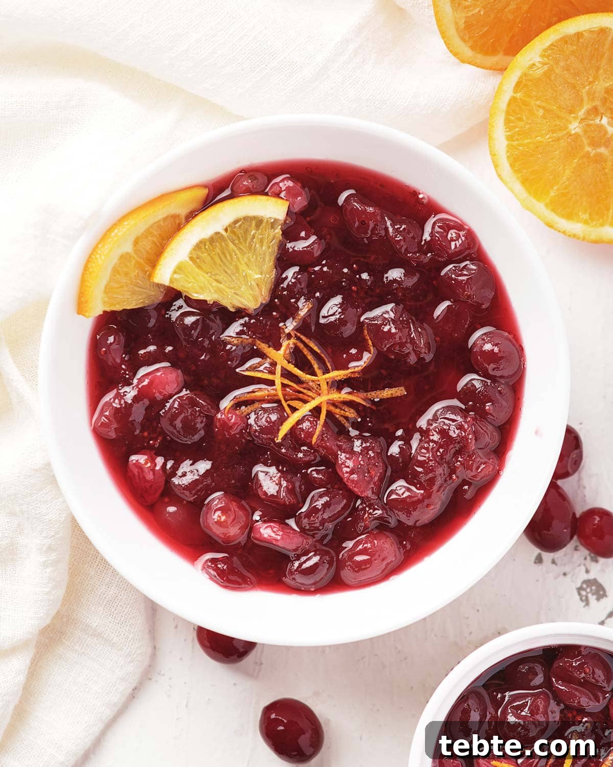 Cranberry Sauce for Instant Pot: Quick Holiday Recipe 2 bowl of cranberry sauce surrounded by oranges and cranberries.