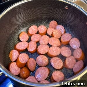 Authentic New Orleans Red Beans and Rice Recipe 4 Sausage being browned in a pot.