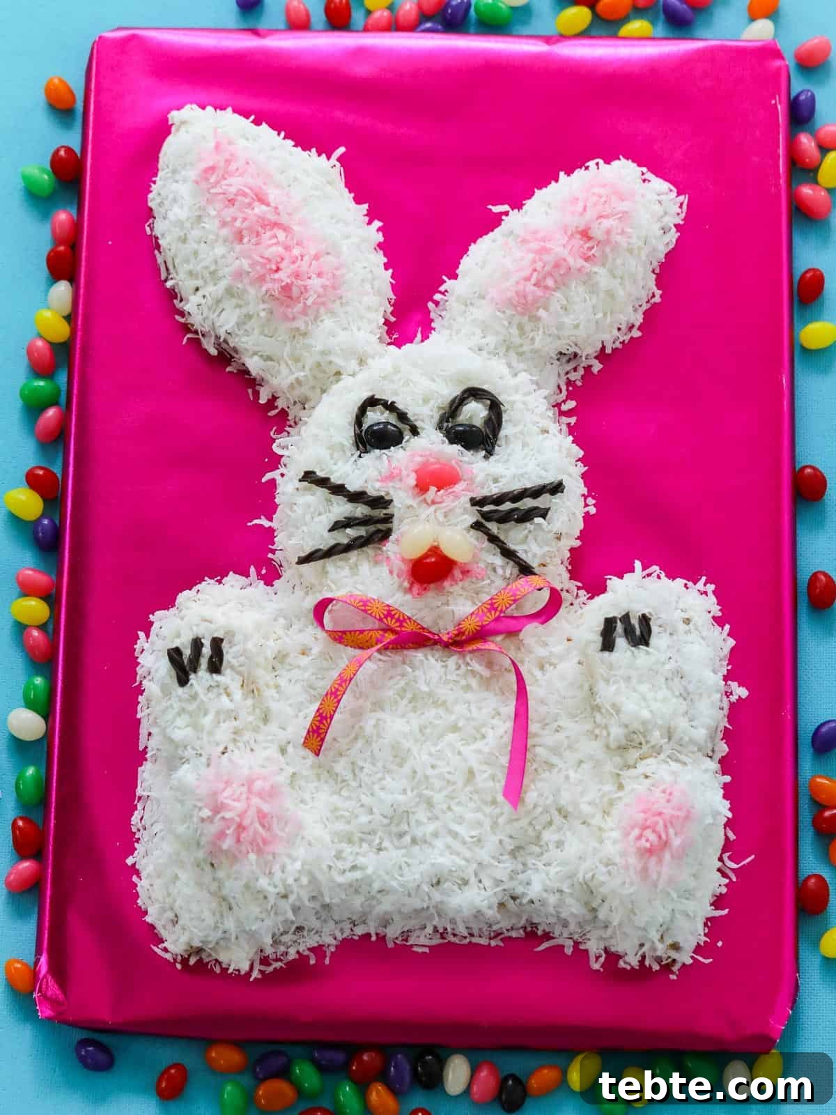 80+ Easter Dinner Menu Ideas for Every Guest and Occasion 5 One of the best Easter Dinner Ideas, an adorable bunny cake on a hot pink table surrounded with jelly beans.