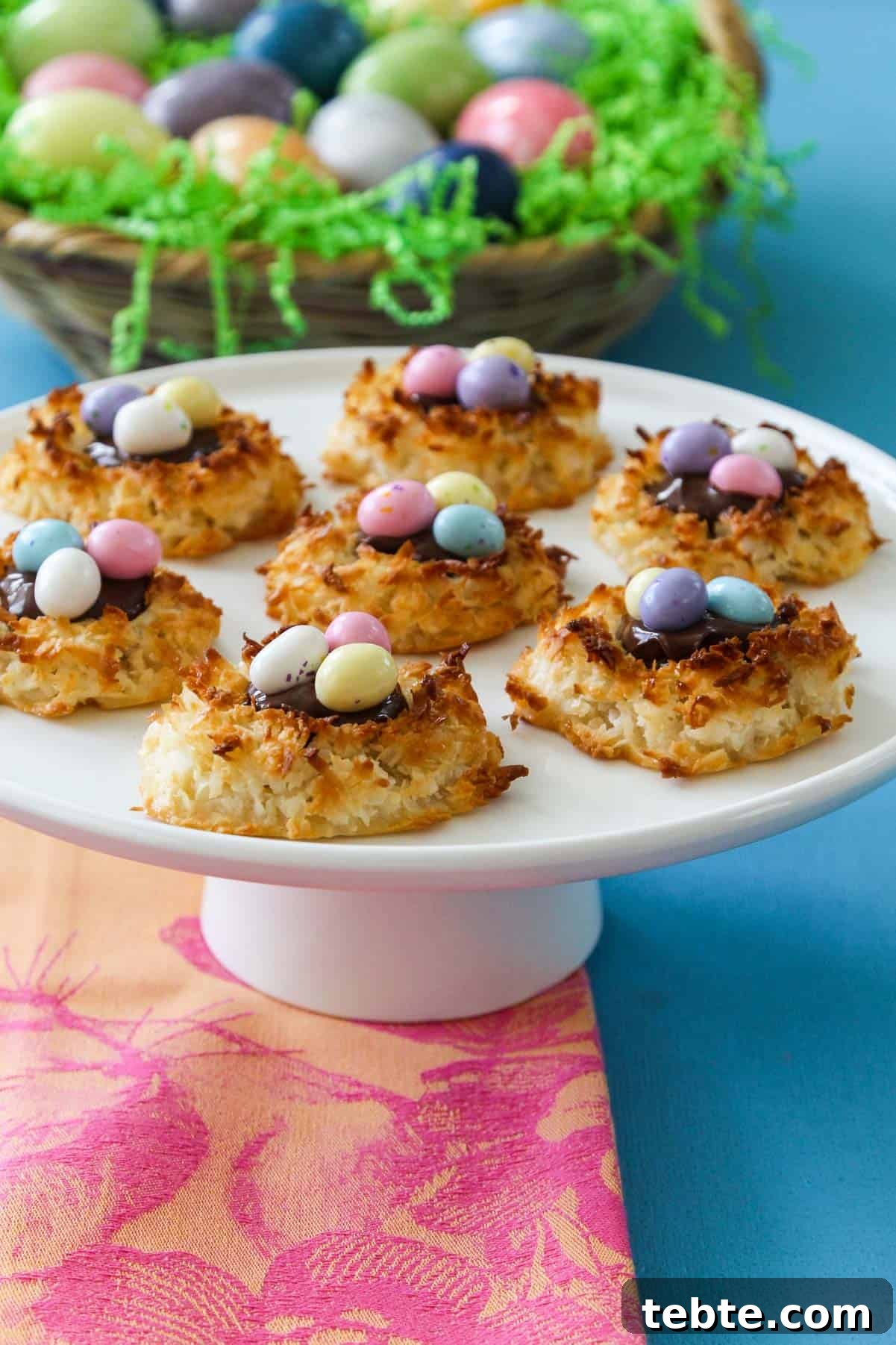 80+ Easter Dinner Menu Ideas for Every Guest and Occasion 7 A great recipe for Easter dinner white cake plate with bird nest coconut marcaroons with candy eggs.