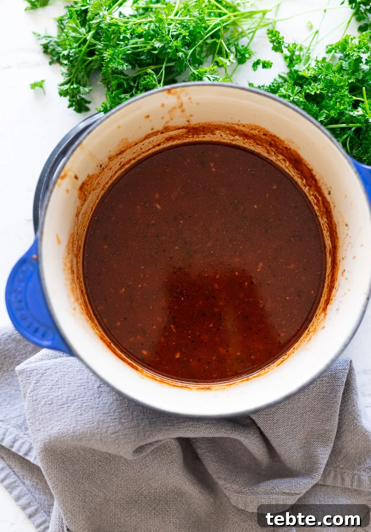 Homemade Red Enchilada Sauce Recipe for Authentic Flavor 8 Red enchilada sauce in a pot on the stove.