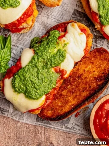 Chicken parmesan sandwich topped with pesto.