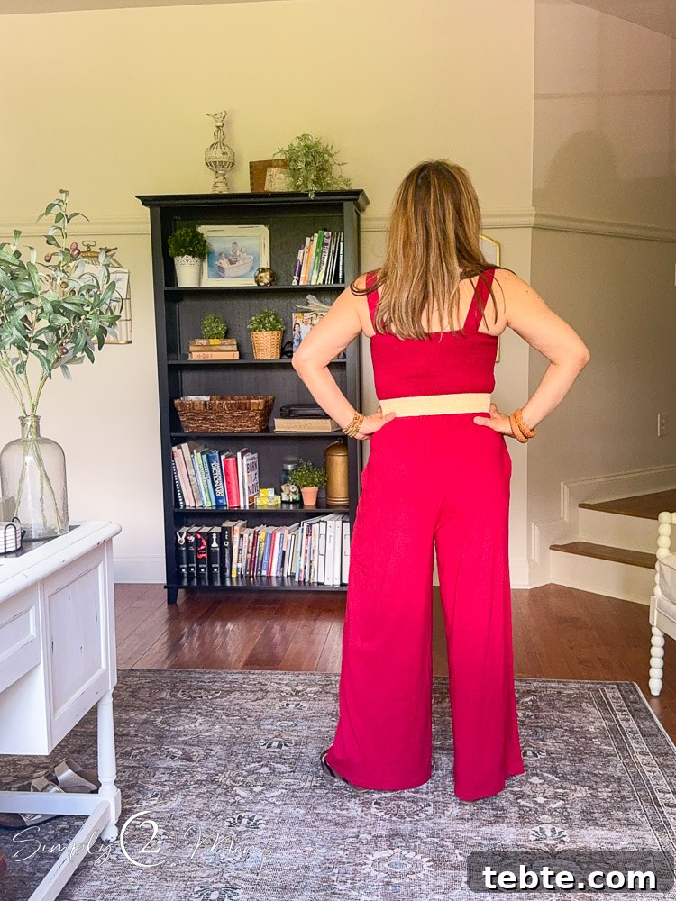 8 Adorable Amazon Jumpsuits and Sundresses You’ll Love 10 Woman wearing a wide legged jumpsuit romper with a straw belt from the back.