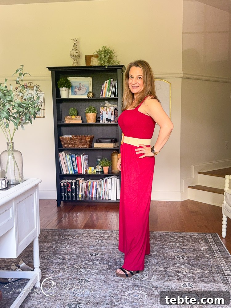 8 Adorable Amazon Jumpsuits and Sundresses You’ll Love 11 Woman wearing a wide legged jumpsuit romper with a straw belt from the side.