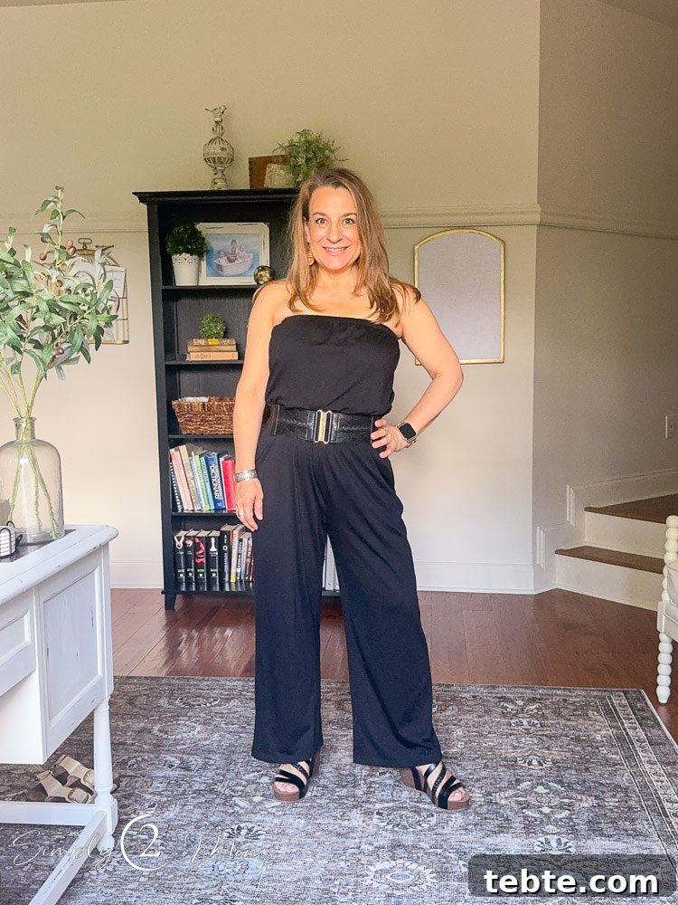 8 Adorable Amazon Jumpsuits and Sundresses You’ll Love 13 Woman wearing a sleeveless jumpsuit with a cinched belt and strappy wedge sandals.