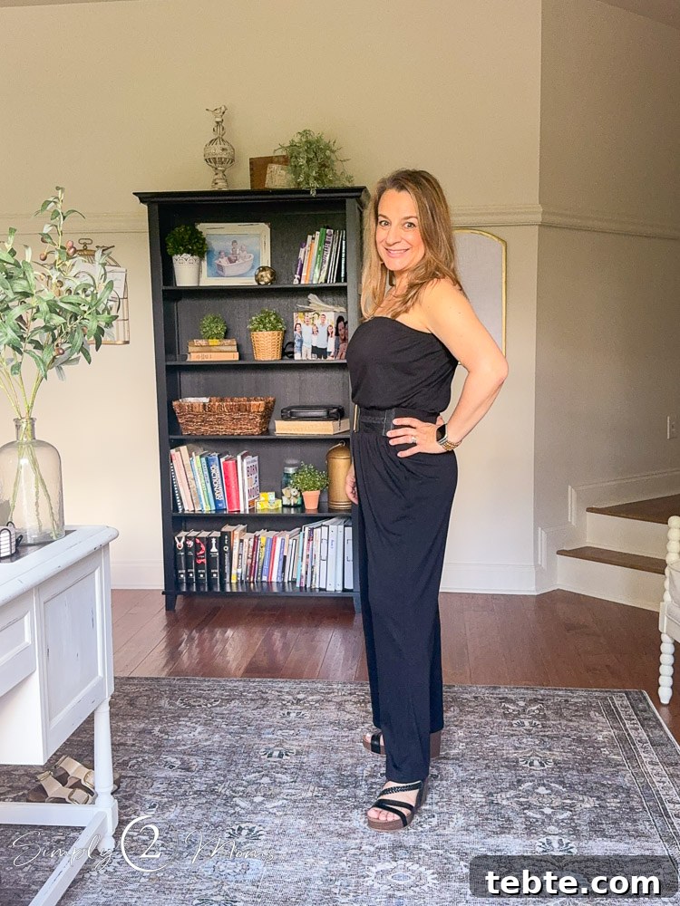 8 Adorable Amazon Jumpsuits and Sundresses You’ll Love 14 Woman wearing a sleeveless jumpsuit with cinched belt and wedge sandals from the side.