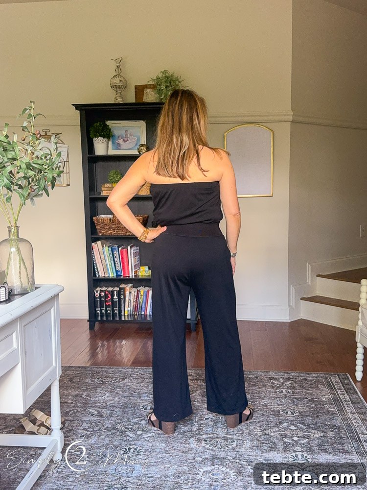 8 Adorable Amazon Jumpsuits and Sundresses You’ll Love 15 Woman wearing a sleeveless jumpsuit with a belt from the back.