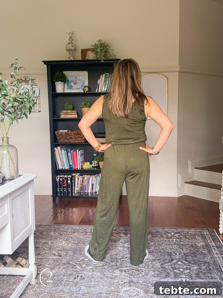 8 Adorable Amazon Jumpsuits and Sundresses You’ll Love 3 Woman wearing a sleeveless jumpsuit from the back.