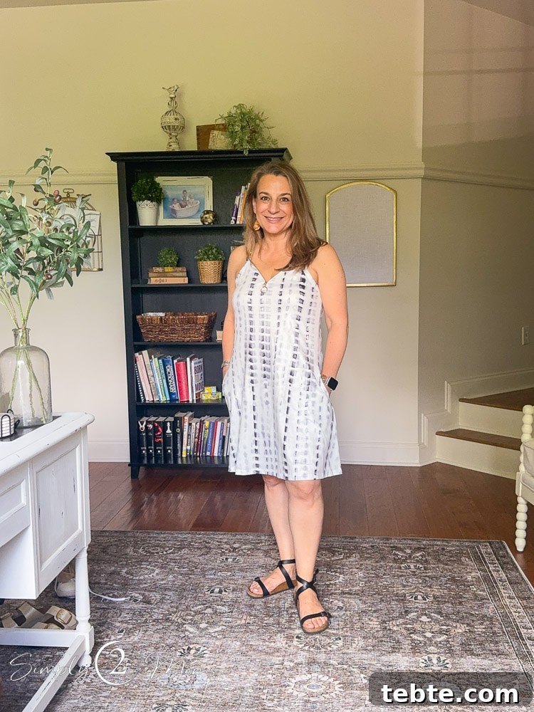 8 Adorable Amazon Jumpsuits and Sundresses You’ll Love 23 Woman wearing a batik printed short sundress with metal ring details on the straps.