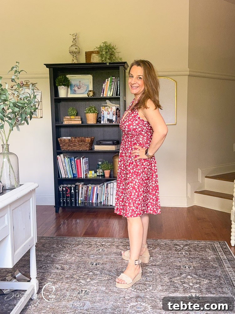 8 Adorable Amazon Jumpsuits and Sundresses You’ll Love 25 Woman wearing red floral halter sundress from Amazon showing how it looks from the side.