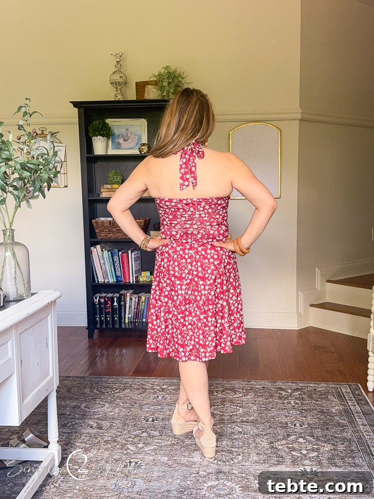 8 Adorable Amazon Jumpsuits and Sundresses You’ll Love 26 Woman wearing red floral halter sundress from Amazon showing how it looks from the back.