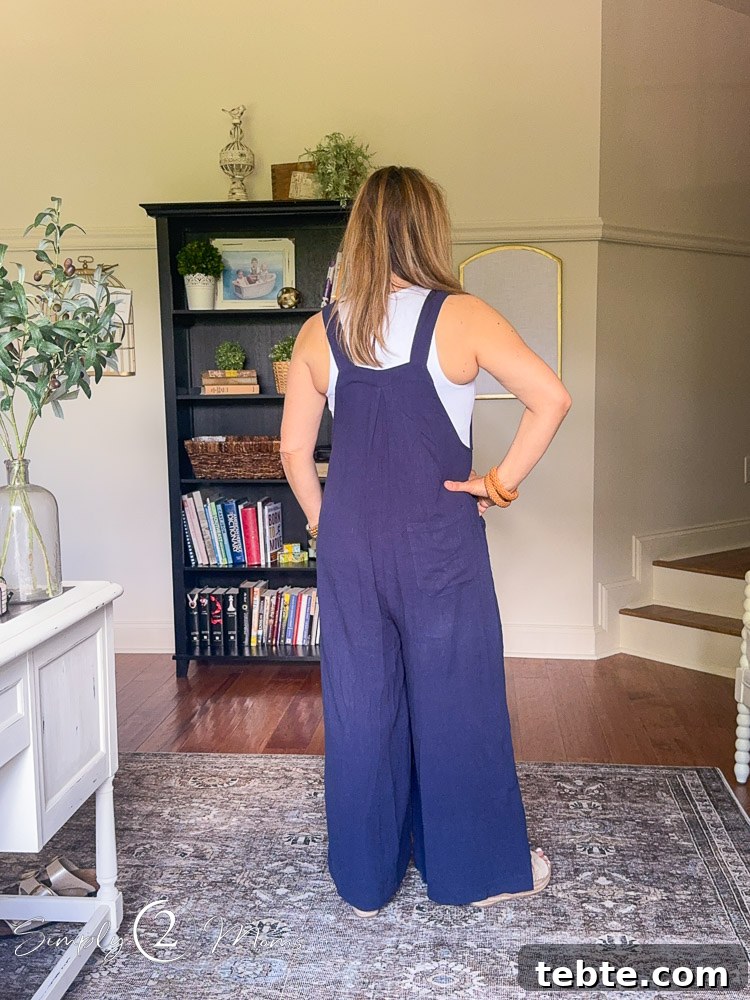 8 Adorable Amazon Jumpsuits and Sundresses You’ll Love 7 Woman wearing wide legged overalls with sleeveless body suit from the back.