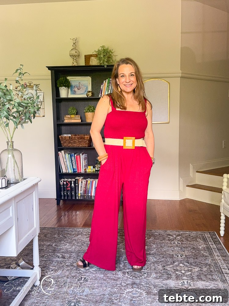 8 Adorable Amazon Jumpsuits and Sundresses You’ll Love 9 Woman wearing a wide legged jumpsuit romper with hands in the pockets and a straw belt.