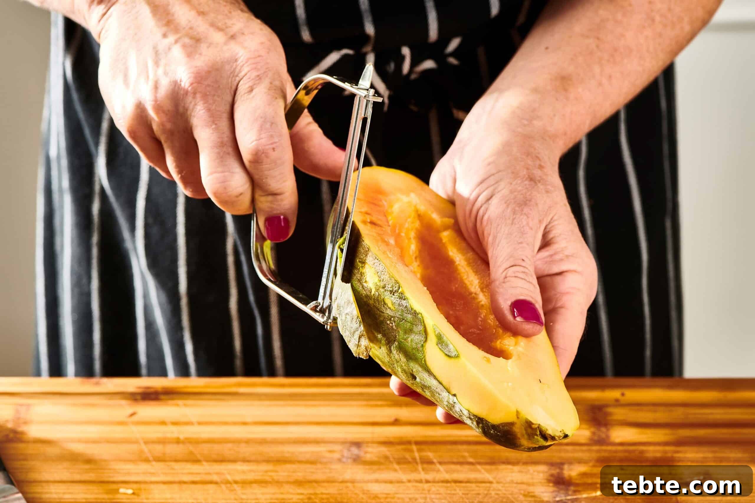 How to Slice and Prepare a Papaya Quickly 6 Woman using a peeler to peel a papaya half.
