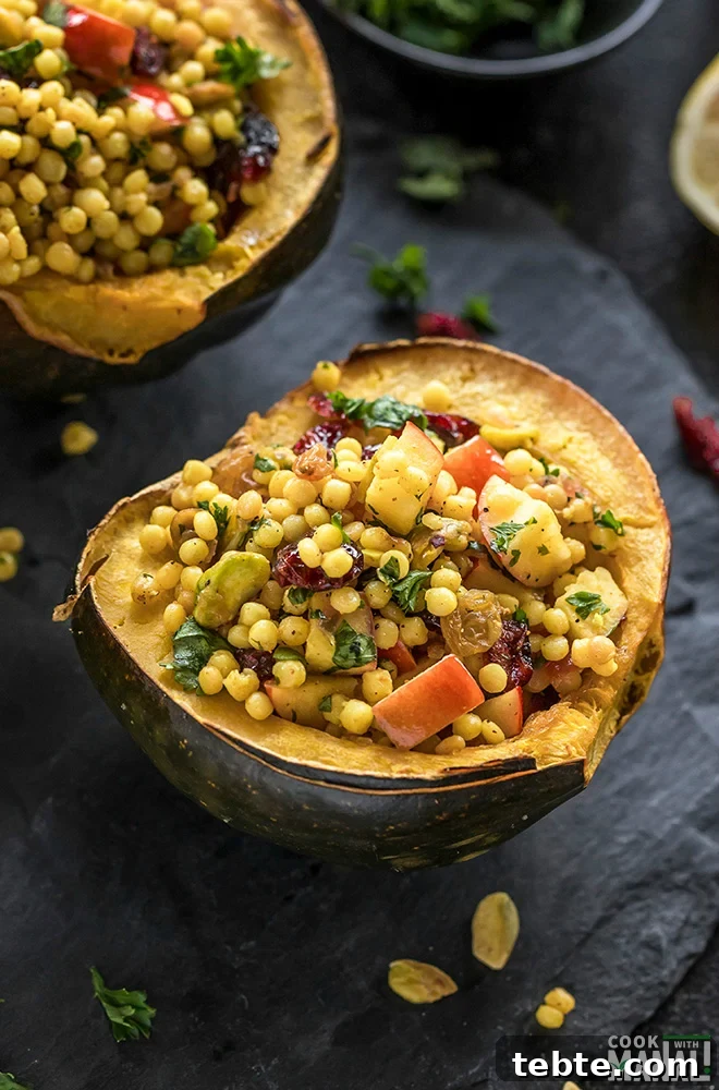 Israeli Couscous-Stuffed Acorn Squash with Herbs and Feta 2 cut acorn squash stuffed with israeli couscous and garnished with fresh herbs