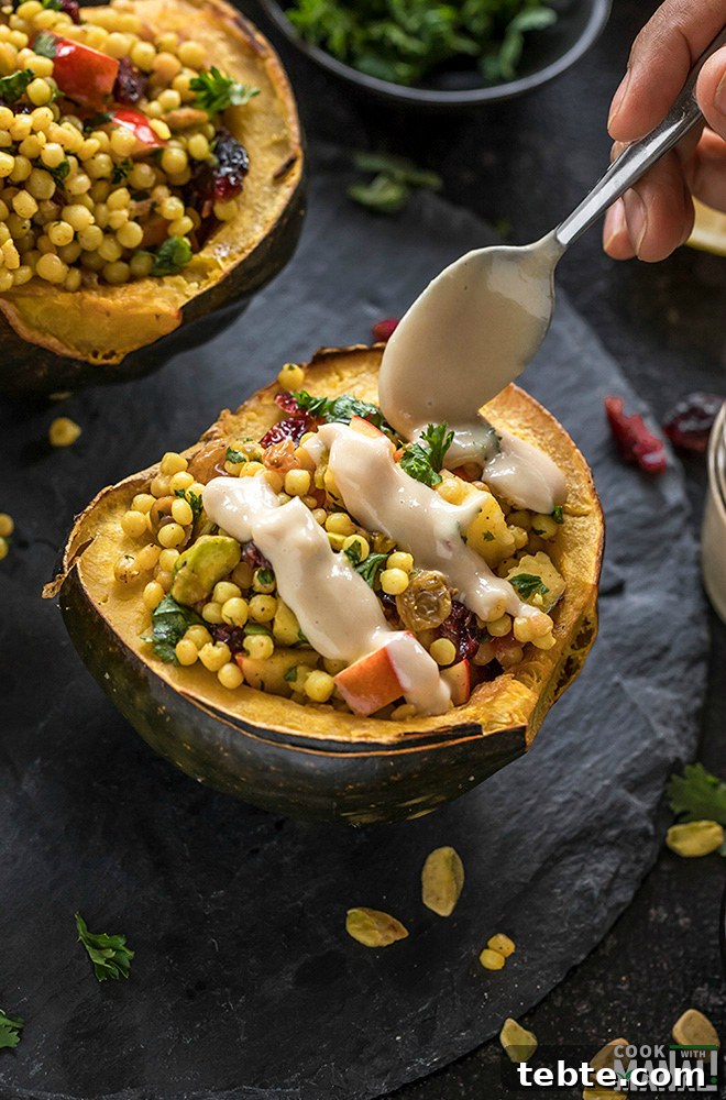 Israeli Couscous-Stuffed Acorn Squash with Herbs and Feta 4 maple tahini dressing drizzled with a spoon over stuffed acorn squash
