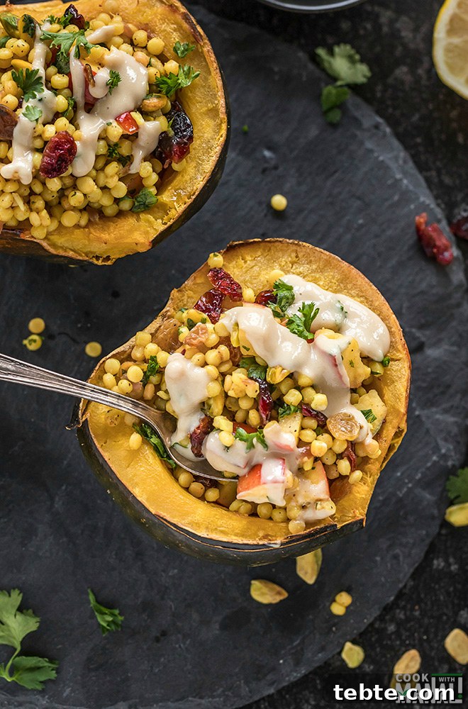 Israeli Couscous-Stuffed Acorn Squash with Herbs and Feta 7 stuffed acorn squash with a spoon and another half of the squash in the background