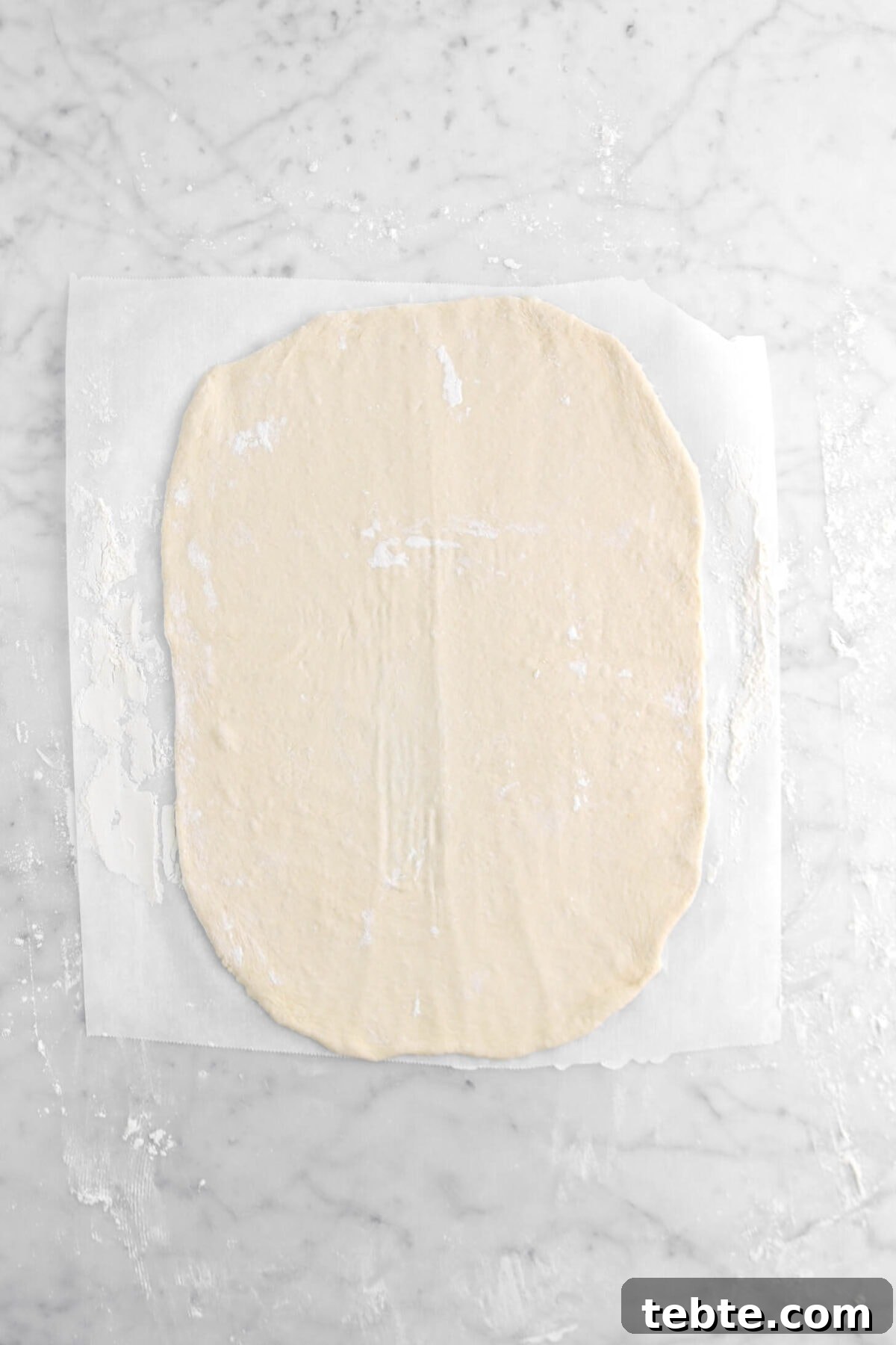 Asparagus, Caramelized Onion & Prosciutto Flatbread with Goat Cheese 11 rolled out pizza dough on parchment paper.