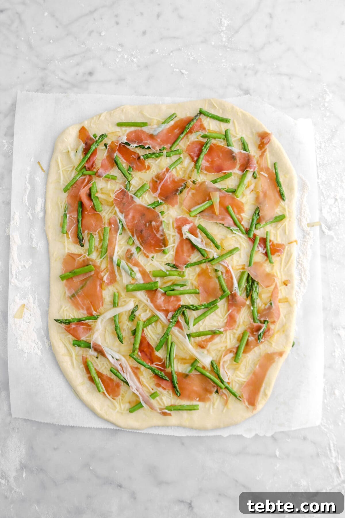 Asparagus, Caramelized Onion & Prosciutto Flatbread with Goat Cheese 16 Prosciutto laid on to of asparagus and onions.