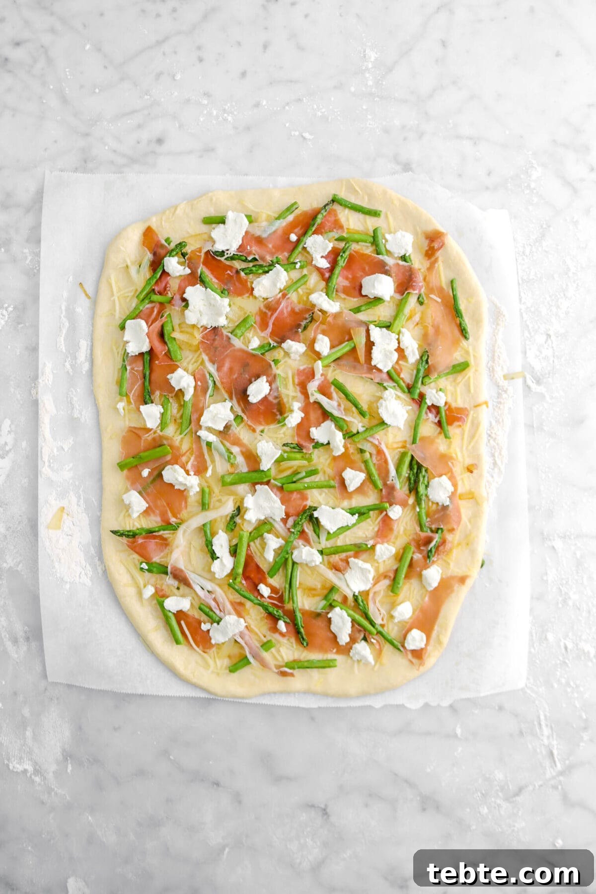 Asparagus, Caramelized Onion & Prosciutto Flatbread with Goat Cheese 17 goat cheese sprinkled on top of prosciutto.
